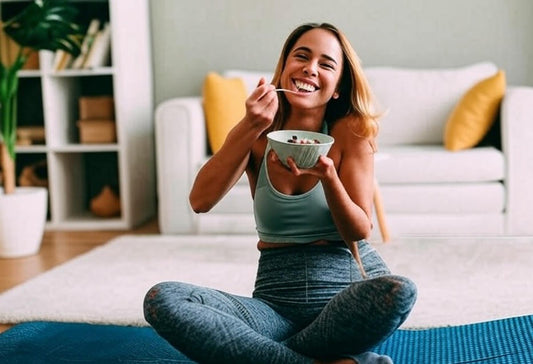 Healthy diet - a very happy young woman eating from a bowl