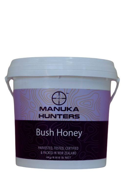 A 4kg container of Manuka Hunters Bush Honey with a white lid and purple label, showcasing the brand and product name.