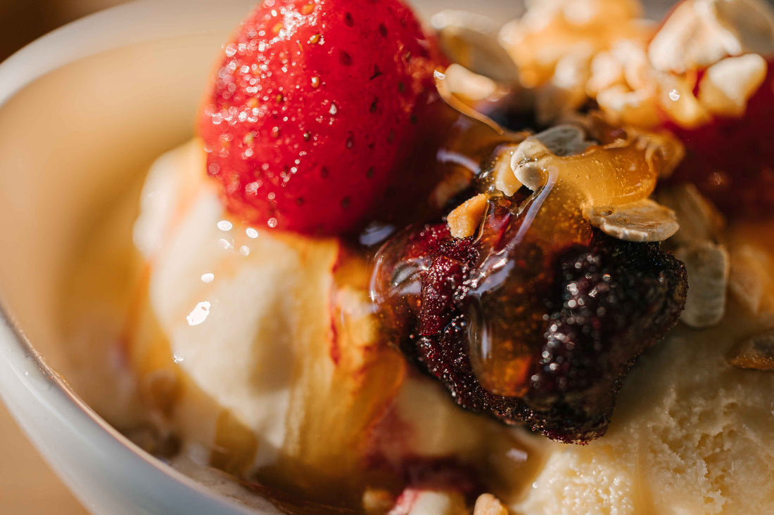 Healthy yoghurt, fruit and nut bowl topped with manuka honey