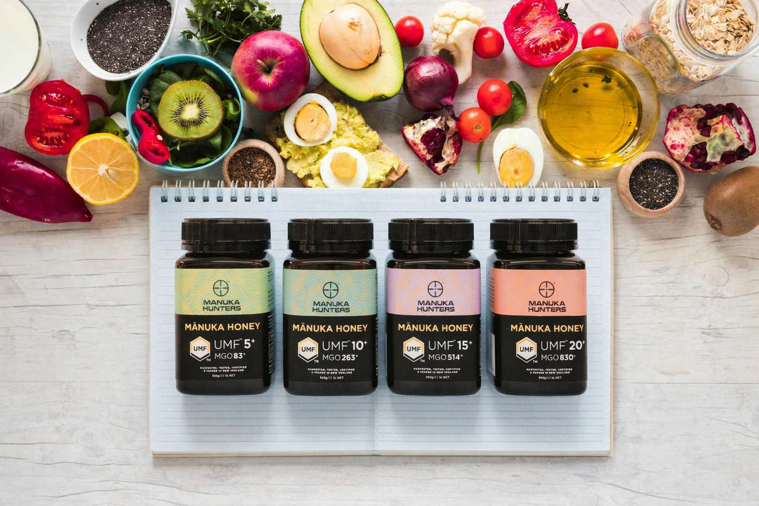 manuka hunters jars of honey, surrounded by healthy food and a notebook 