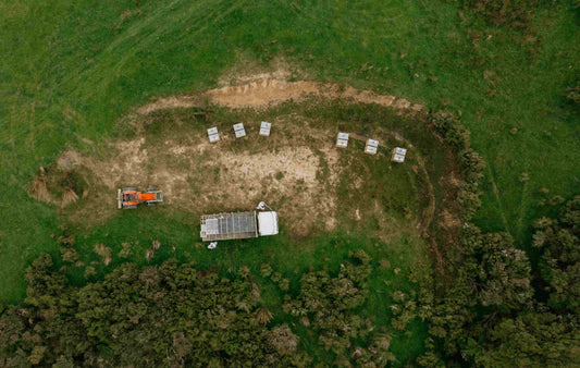 Aerial view of manuka honey hives with a truck and tractor at a remote New Zealand apiary