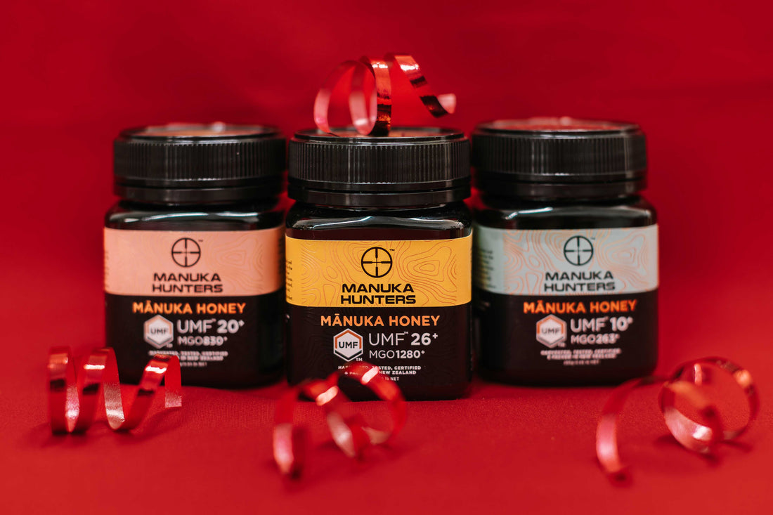 Manuka Honey Gift jars, showcased on a red background