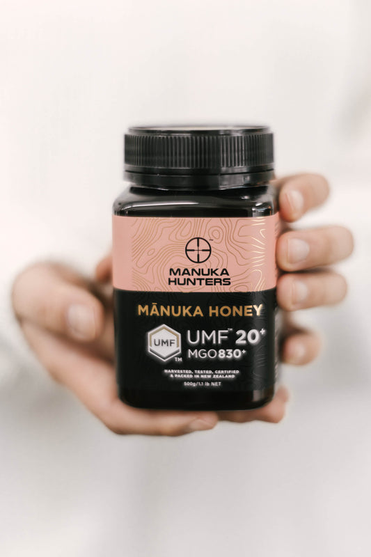 female hands presenting a Manuka Hunters honey jar for a close-up photo shoot