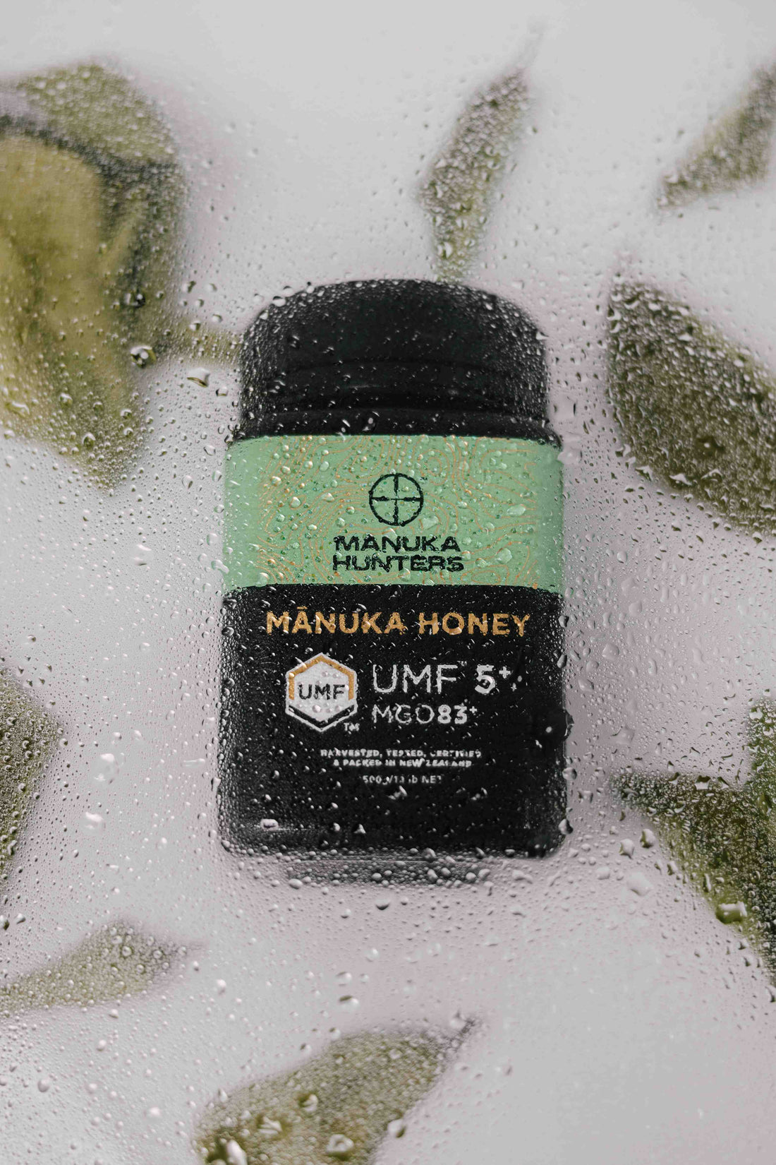 manuka hunters honey jar under some ice for a photo shoot