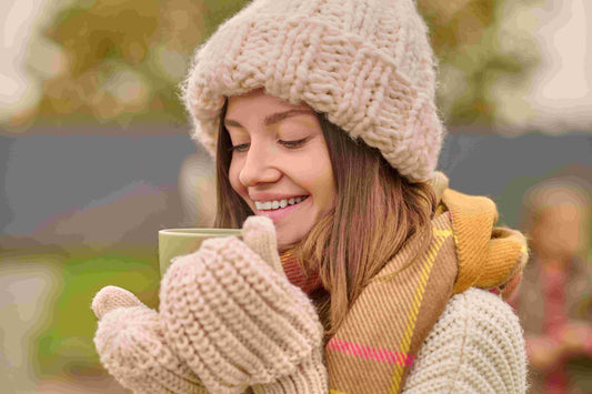 woman-knitted-clothes-looking-with-pleasure-into-hot drink cup